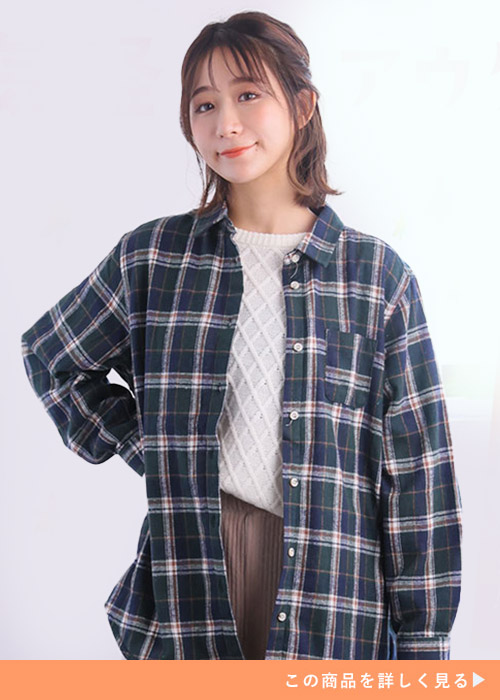 白ニット×ブラウンパンツに、グリーン系のチェック柄シャツを羽織る女性